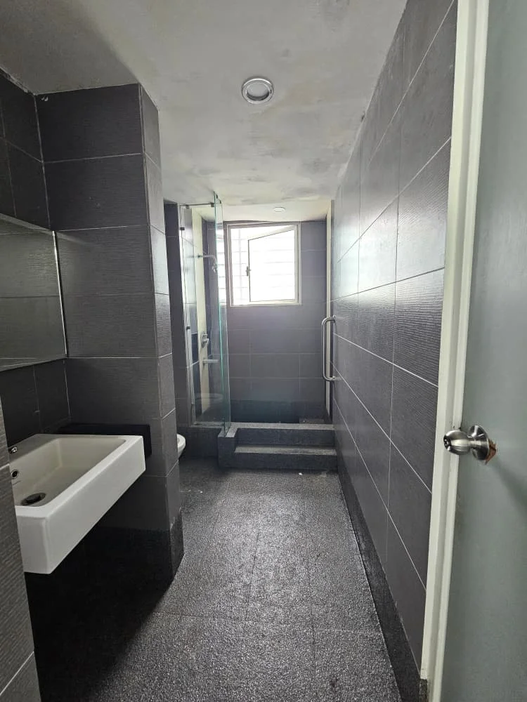 Bathroom features: grey tiled walls, black tiled flooring, single-sink vanity with wall-mounted faucet, mirror above sink, walk-in shower with glass enclosure, shower head, toilet, window for natural light, grab bar, step-up area to shower, recessed ceiling lights; style: modern.